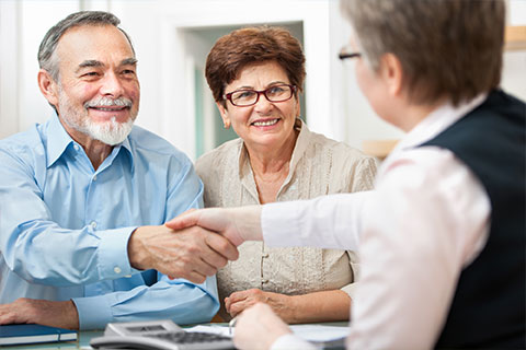 Couple shaking hand with agent discussing General Liability Insurance in Columbus, IN, Madison, IN, North Vernon, and Nearby Cities