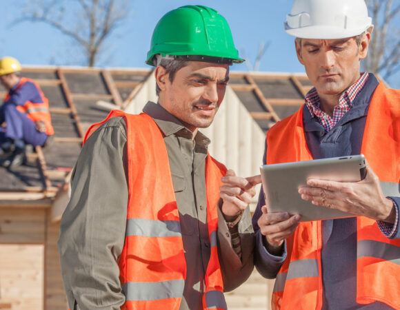 Two workers at a jobsite going over their Commercial Insurance for Contractors
