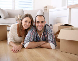 Couple Laying in Living Room with Boxes After Getting Home Insurance in Columbus, IN