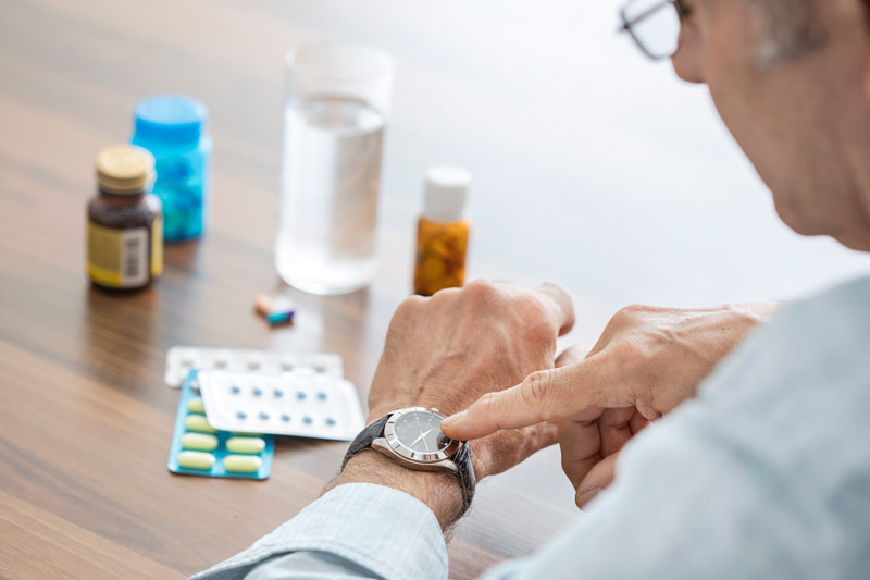 Elderly Man Checking Time for Prescriptions for Medicare Advantage Open Enrollment in Seymour, IN