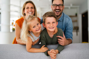 Family Smiling in Home After Getting a Good Home Insurance Policy in Seymour, IN