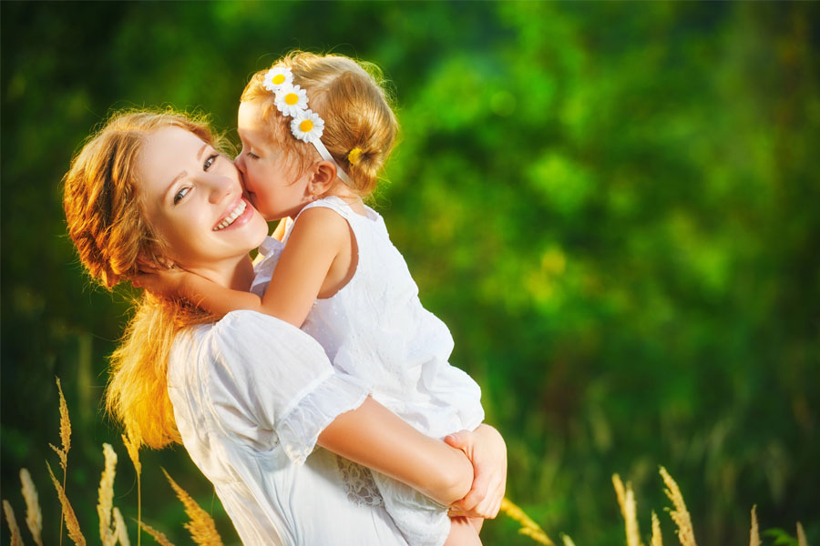 A Mom with Long Term Care Insurance, Holding Her Daughter in a Columbus, IN Field