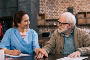 man speaking with nurse that has Life Insurance & Long-Term Care Insurance in Seymour, IN