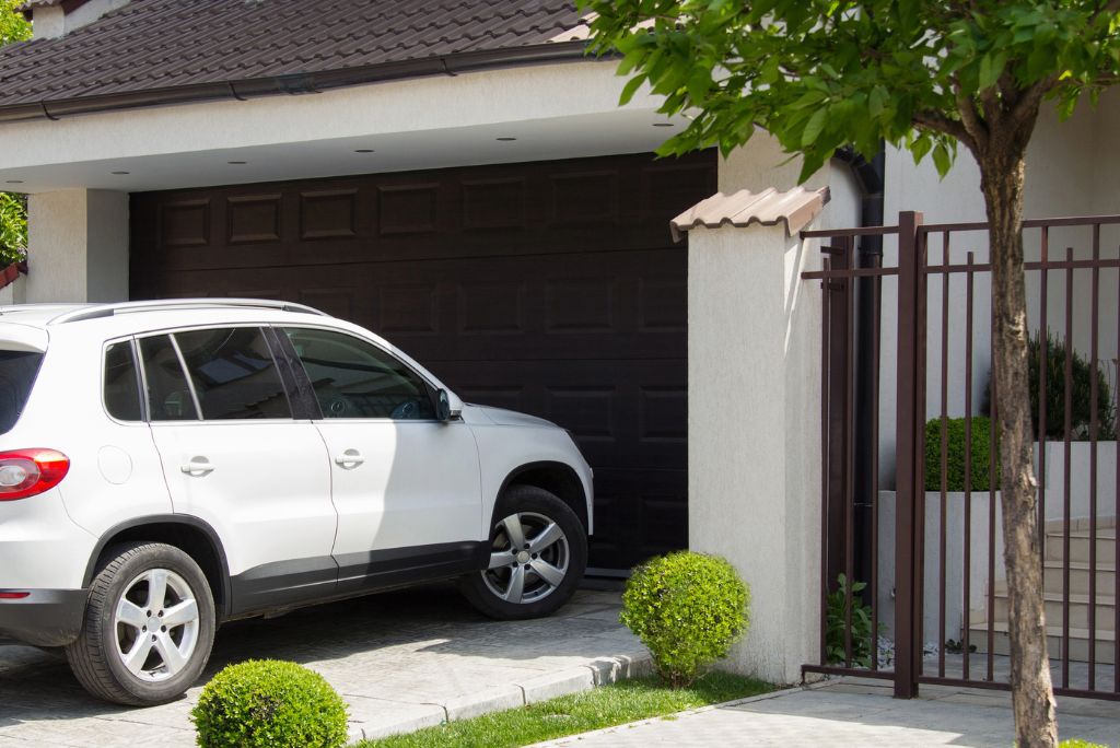 SUV in front of a home in Madison, IN with an Auto Home Insurance Bundle